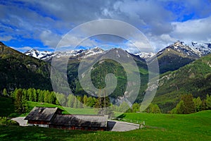 Summer green mountains with blue sky and white clouds. Mountains in the Alps. Mountain scenery in summer. Green meadow with