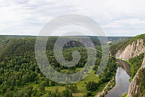 Summer green valley river mountain  landscape. Winding river with overgrown banks, top view. Aerial shot of nature