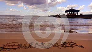 Summer handwriting at tropical beach at sunset