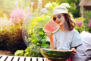 Summer happy child girl eating watermelon outdoor on vacation