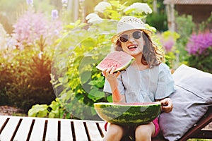 Summer happy child girl eating watermelon outdoor on vacation