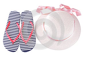 hat with a pink ribbon and flip flops in blue and white stripes. Isolated photo