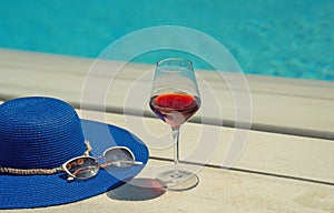 Summer hat, sunglasses and glass of wine