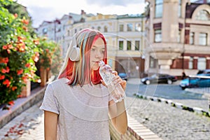 Summer, heat in city, young woman with bottle of water