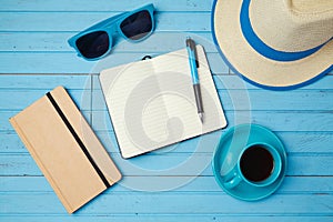 Summer holiday background with notebook and coffee cup. Vacation planning concept.