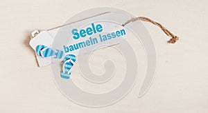 Summer holiday concept with german text for let your mind dangli