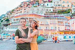 Summer holiday in Italy. Young couple in Positano village on the background, Amalfi Coast, Italy