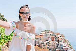 Summer holiday in Italy. Young woman in old village on the background of italian coast