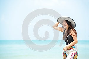 Summer Holiday.  Lifestyle smiling asian woman wearing bikini fashion summer trips relax on the sandy ocean beach. Happy woman enj