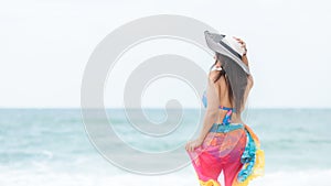 Summer Holiday. Lifestyle woman chill holding big white hat and wearing bikini fashion summer trips photo