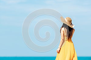 Summer Holiday. Lifestyle woman chill holding big white hat and wearing yellow dress fashion summer trips standing chill on the sa