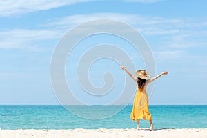 Summer Holiday. Lifestyle woman chill holding big white hat and wearing yellow dress fashion summer trips standing chill on the sa photo
