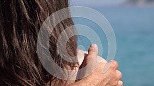 Summer holiday, man hand caressing woman shoulders