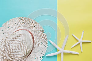 Summer holiday minimal background concept. Straw hat, starfishes