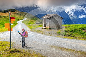 Mountain hiking trails and hiker woman with map, Switzerland, Europe photo