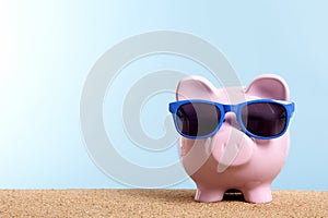 Summer holiday savings concept, travel money planning, Piggy bank on beach vacation, copy space