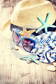 Summer holiday setting with straw hat and sunglasses