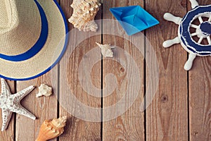 Summer holiday travel background with seashells and paper boat. View from above. Flat lay