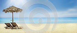 Summer holiday travel background. Sun umbrella and chairs on sandy beach