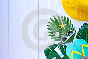 Summer holiday of traveler. Top view from above of beach accessories and a hat with sunglasses and sandals on white table backgrou