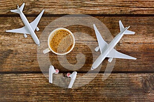 Summer holiday traveling concept planning model plane airplane and headphones in coffee cup