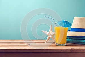 Summer holiday vacation background with orange juice, starfish and hat.