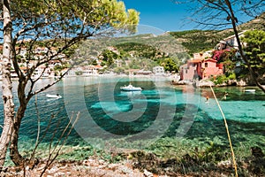Summer holiday vacation in Greece. Transparent mediterranean cove and small town Assos. Kefalonia Greece