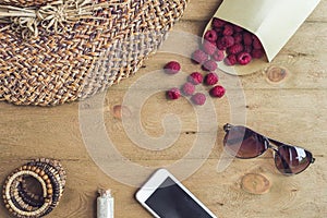 Summer holiday, vacation, relaxation concept. Raspberries, straw