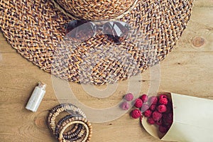Summer holiday, vacation, relaxation concept. Raspberries, straw