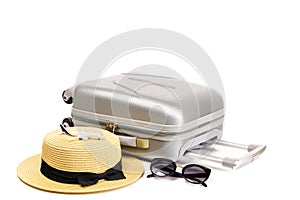 Summer holidays background. Womens accessories traveler: suitcase, straw hat, sunglasses and toy plane isolated on white