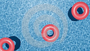 Summer holidays banner. Swimming pool top view. Three red swimming rings in the empty clear pool.