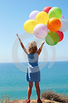 summer holidays, celebration, family, children and people concept - happy girl with colorful balloons