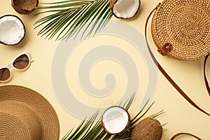 Summer holidays concept. Top view photo of sunhat sunglasses round rattan bag cracked coconuts and green palm leaves on isolated