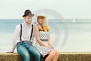 Loving couple retro style dating on sea coast