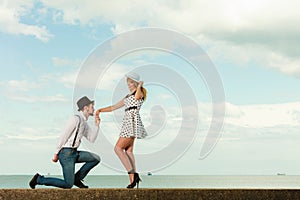 Loving couple retro style dating on sea coast