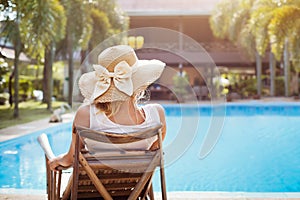 Summer holidays in luxury hotel, woman relaxing in deckchair