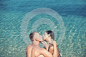 Summer holidays and travel vacation. woman and man swim in sea water. Love relations of kissing couple enjoying