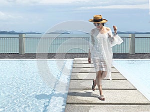 Summer holidays and vacation - Happy woman on the pool side in Phuket, Thailand