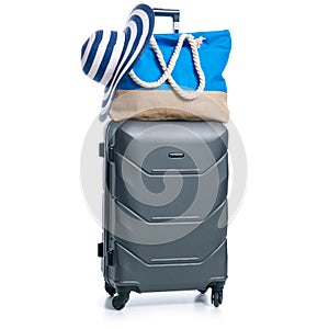 Summer holidays, vacation and travel concept. Suitcase, luggage with beach bag and straw hat