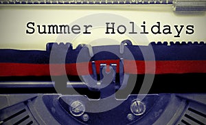 Summer Holydays text on white sheet in vintage typewriter photo