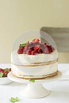 Summer home biscuit cake with curd cream, decorated with fresh berries of strawberries, raspberries and currants