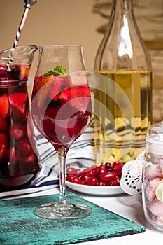 Summer home wine with fruits, sangria cocktail, dogwood berries plate