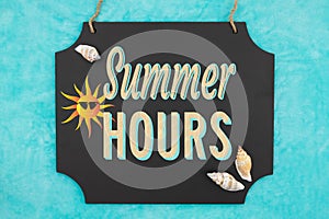Summer Hours hanging chalkboard sign with seashells