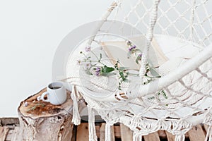 Summer hygge concept with hammock chair in the garden