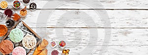 Summer ice cream bar top view corner border over a rustic white wood banner background