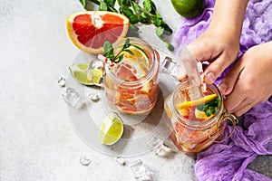 Summer ice refreshing drink. Fresh mojito cocktail with grapefruit, lime and mint in a glass