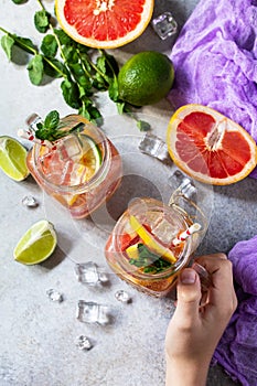 Summer ice refreshing drink. Fresh mojito cocktail with grapefruit, lime and mint in a glass