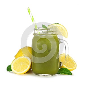 Summer iced matcha lemonade in a mason jar glass with lemons isolated on white