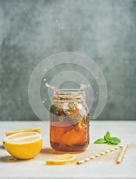 Summer Iced tea with lemon and herbs, copy space