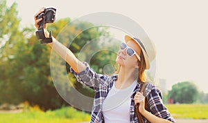 Summer image of young woman taking selfie picture by camera